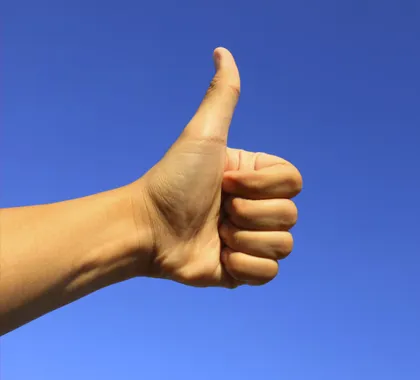 A hand giving a thumbs-up gesture